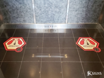 Social distancing floor decals installed in an elevator